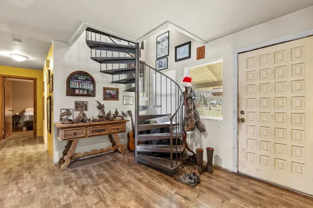 a view of front door with entryway and stairs