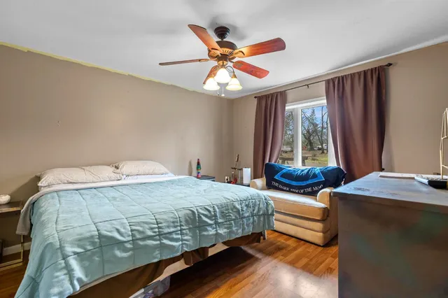 a bedroom with a bed and window