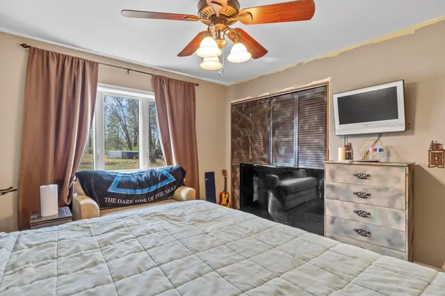 a bedroom with a bed and a television