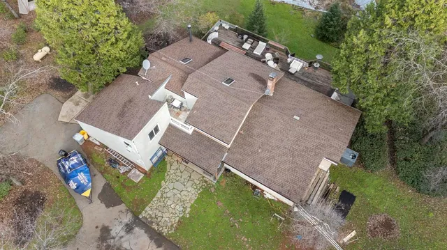 an aerial view of a house with a yard