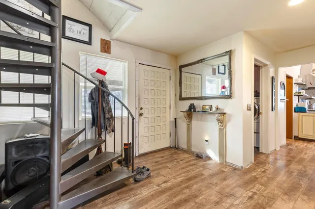 a bedroom with furniture and a kitchen