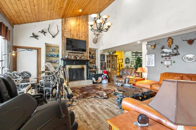 a living room with fireplace furniture and a flat screen tv