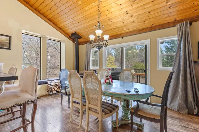 a view of a dining room with furniture wooden floor and a chandelier