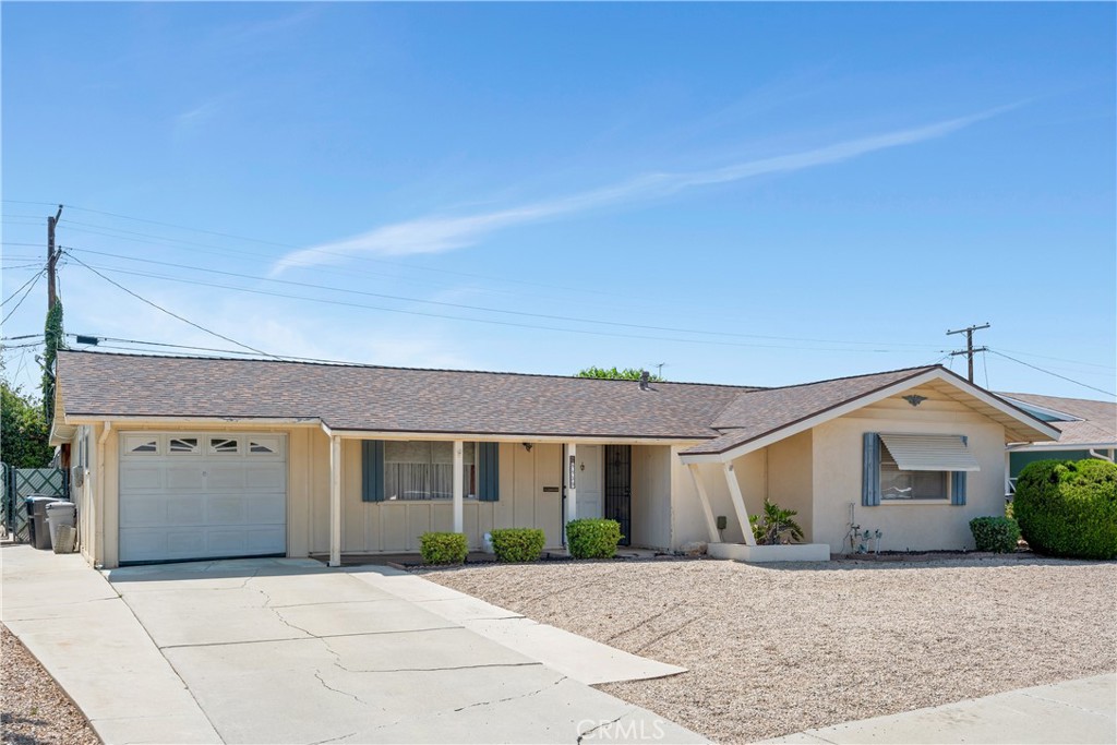 28839 Carmel Road Menifee, CA 92586 - Photo 2 of 47 a front view of a house with a yard and garage
