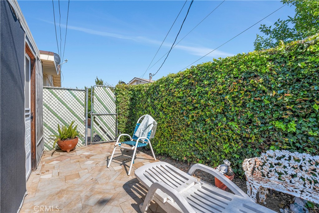 28839 Carmel Road Menifee, CA 92586 - Photo 30 of 47 a balcony with a potted plant and outdoor seating