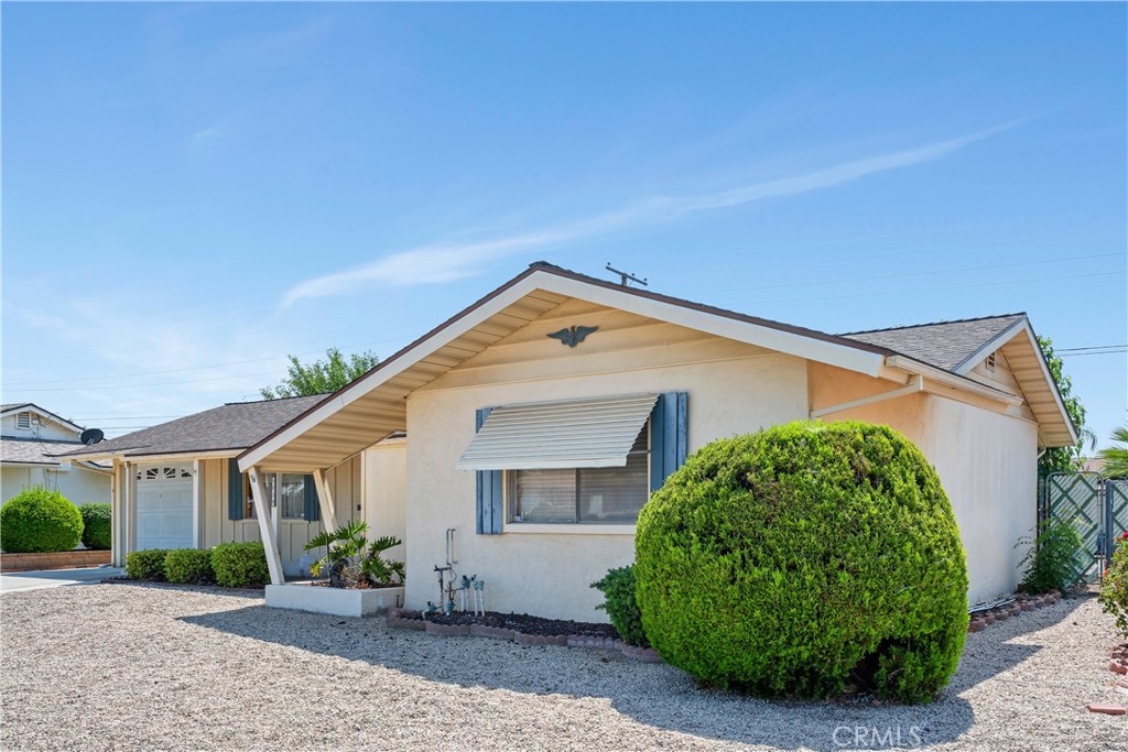 28839 Carmel Road Menifee, CA 92586 - Photo 3 of 47 a view of a house with a yard and potted plants