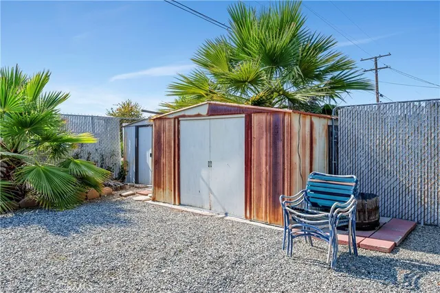 a wooden bench sitting in front of a house