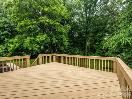 a view of deck with patio and yard