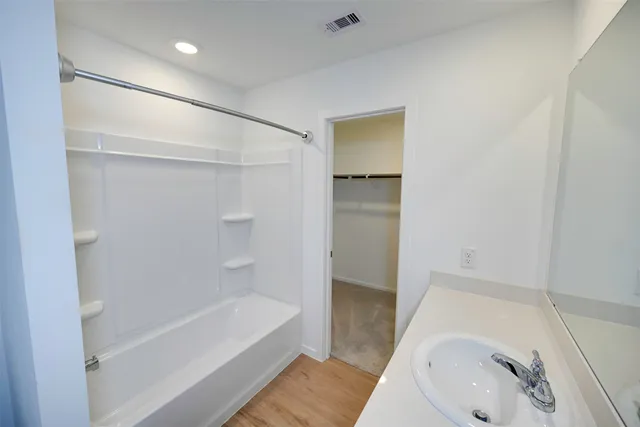 a bathroom with a tub and a shower