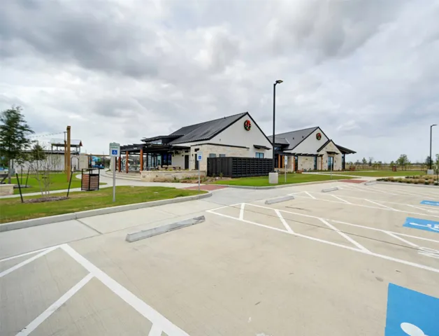 a view of a house with a big yard and large trees