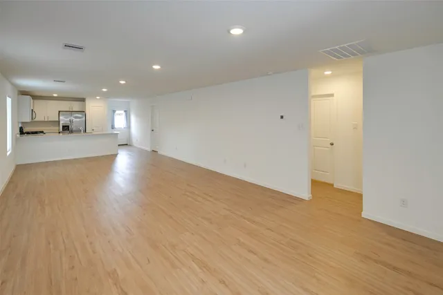 a view of a hallway with wooden floor