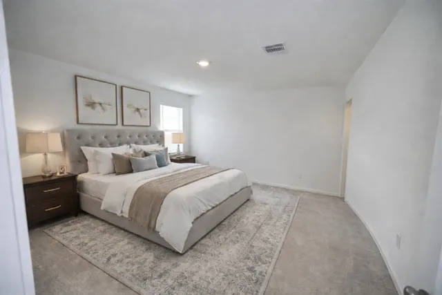 a bed room with a bed and a night stand