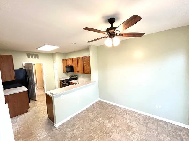 a view of a kitchen with a sink and a refrigerator