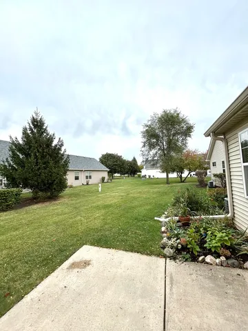 a view of a garden with a building in the background