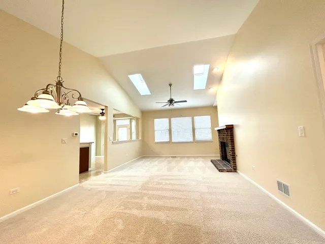 a view of a kitchen with a sink and a chandelier