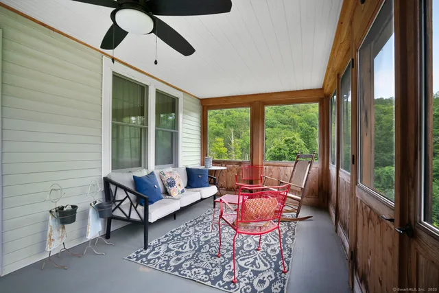 a living room with furniture and a floor to ceiling window