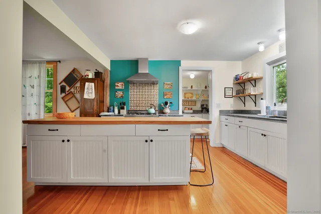 a kitchen with stainless steel appliances granite countertop a sink and cabinets