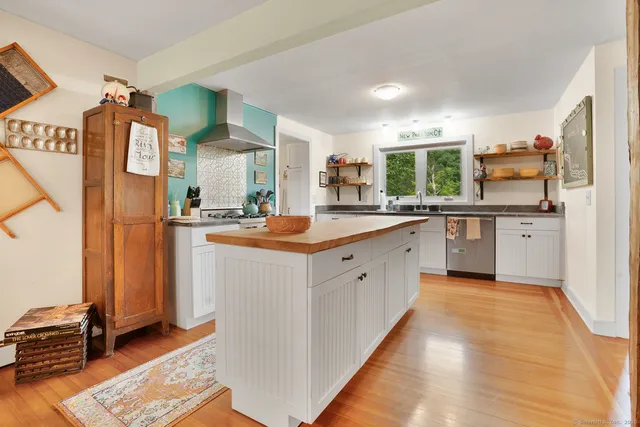 a kitchen with stainless steel appliances granite countertop a sink and cabinets