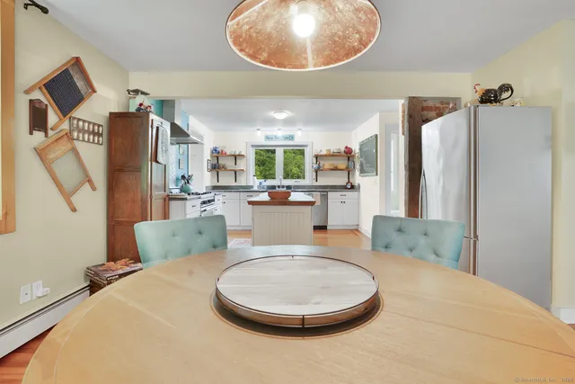 a living room with furniture a kitchen and a table