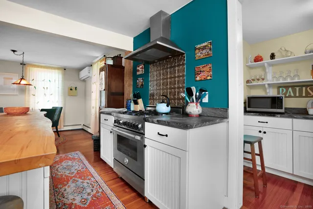 a kitchen with stainless steel appliances granite countertop a stove and cabinets
