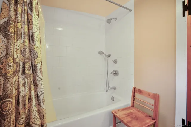 a bathroom with a bathtub and shower
