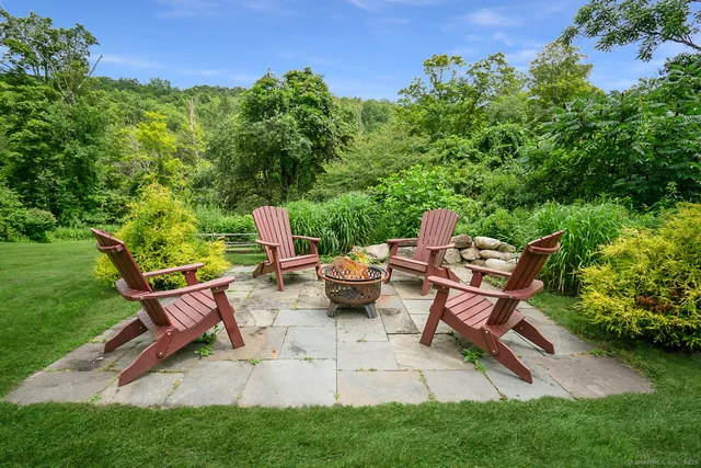 a view of a backyard with table and chairs with a garden
