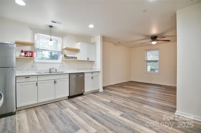 an empty room with wooden floor and cabinet