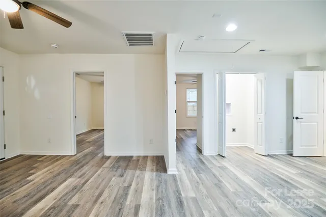 a view of a room with wooden floor