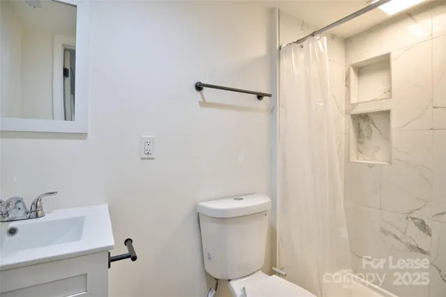 a white toilet sitting next to a bathroom sink