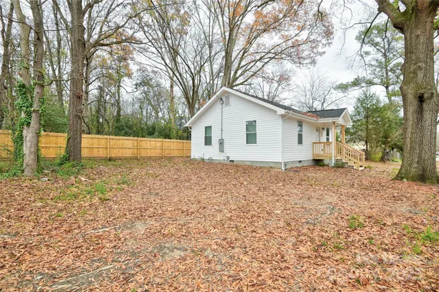 a white house that has a tree in front of it