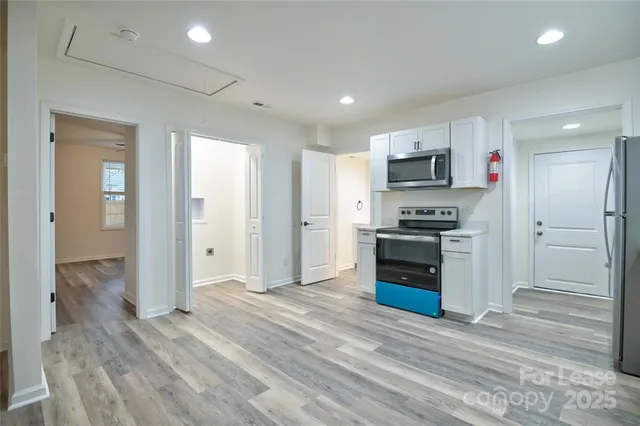 a view of a kitchen with a sink and a refrigerator