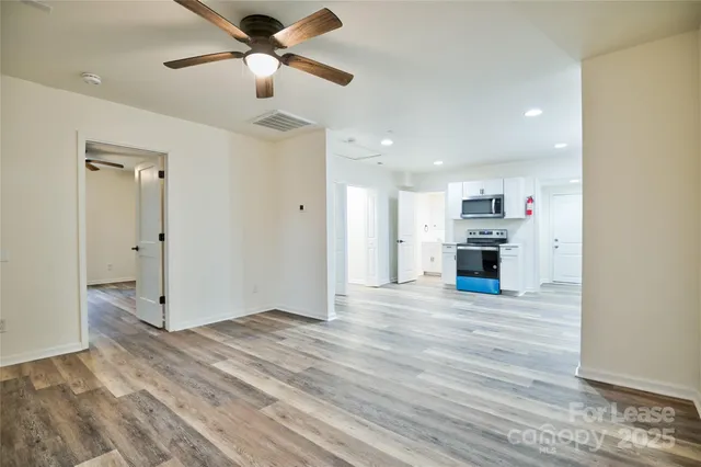 a view of kitchen with wooden floor electronic appliances and window