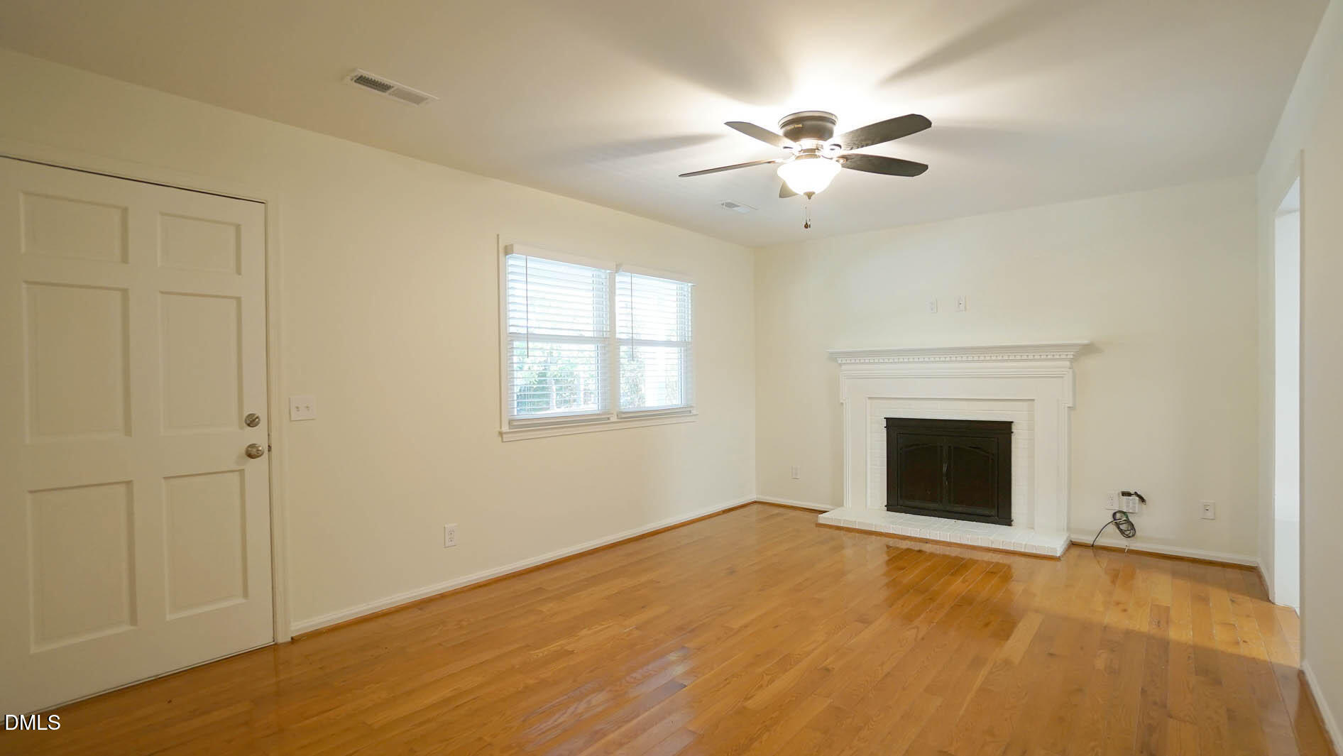 812 Havenwood Court Raleigh, NC 27615 - Photo 11 of 32 a view of empty room with a fireplace and fan