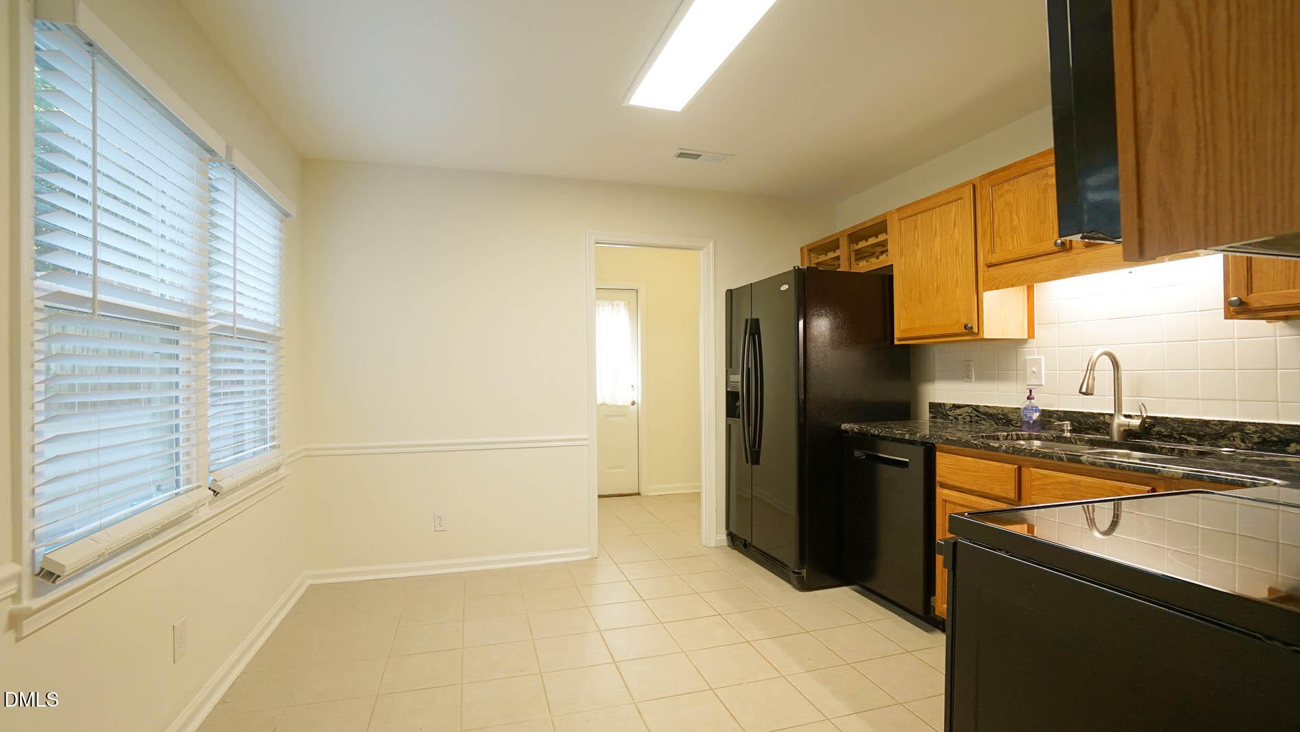 812 Havenwood Court Raleigh, NC 27615 - Photo 14 of 32 a kitchen with granite countertop a refrigerator and a sink