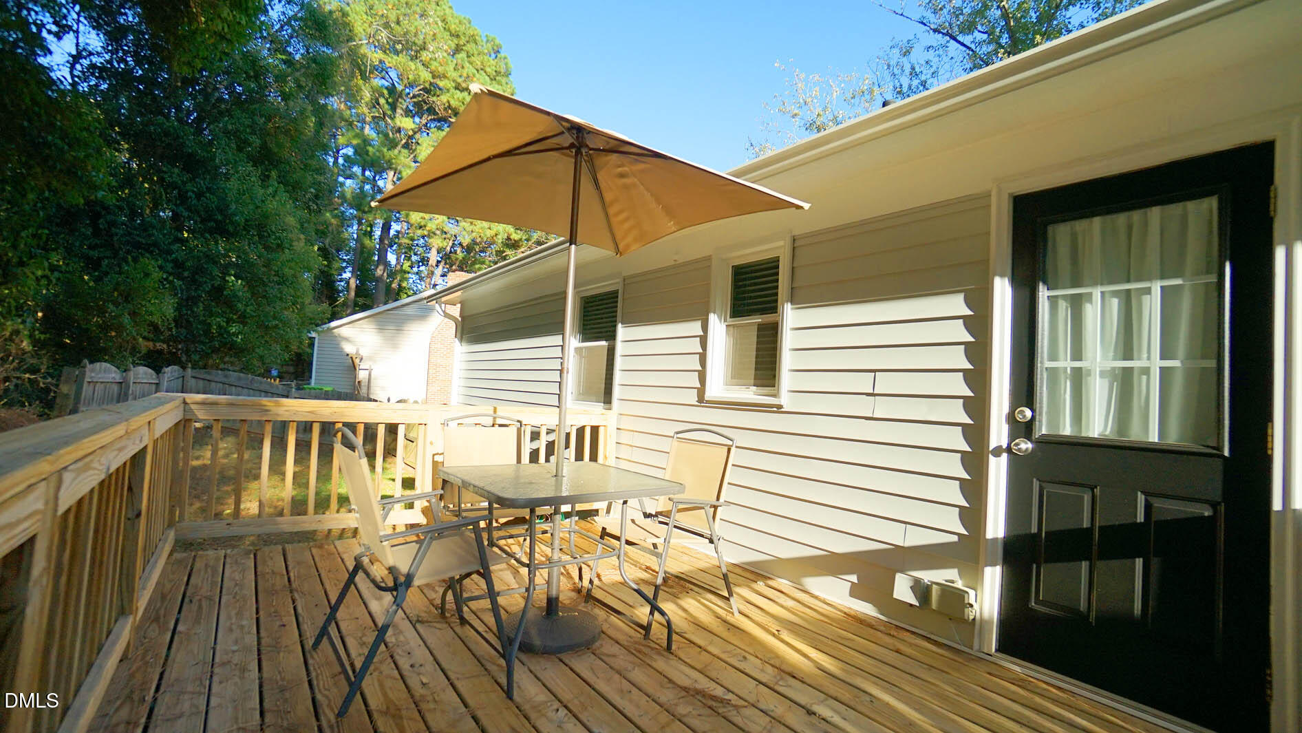 812 Havenwood Court Raleigh, NC 27615 - Photo 26 of 32 a view of deck with table and chairs under an umbrella