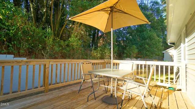 a view of balcony with wooden floor and outdoor seating