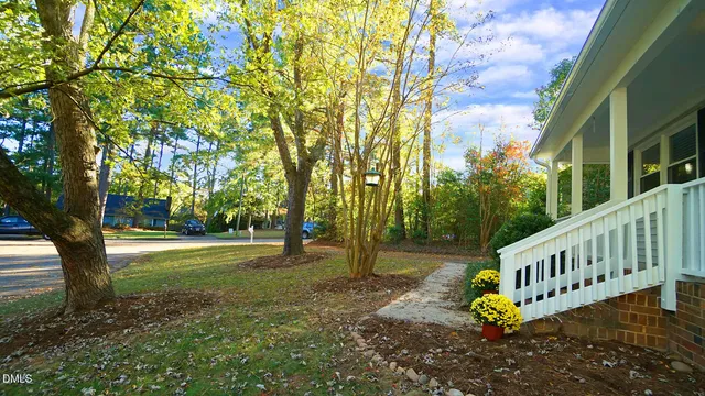 a view of a house with backyard and a tree