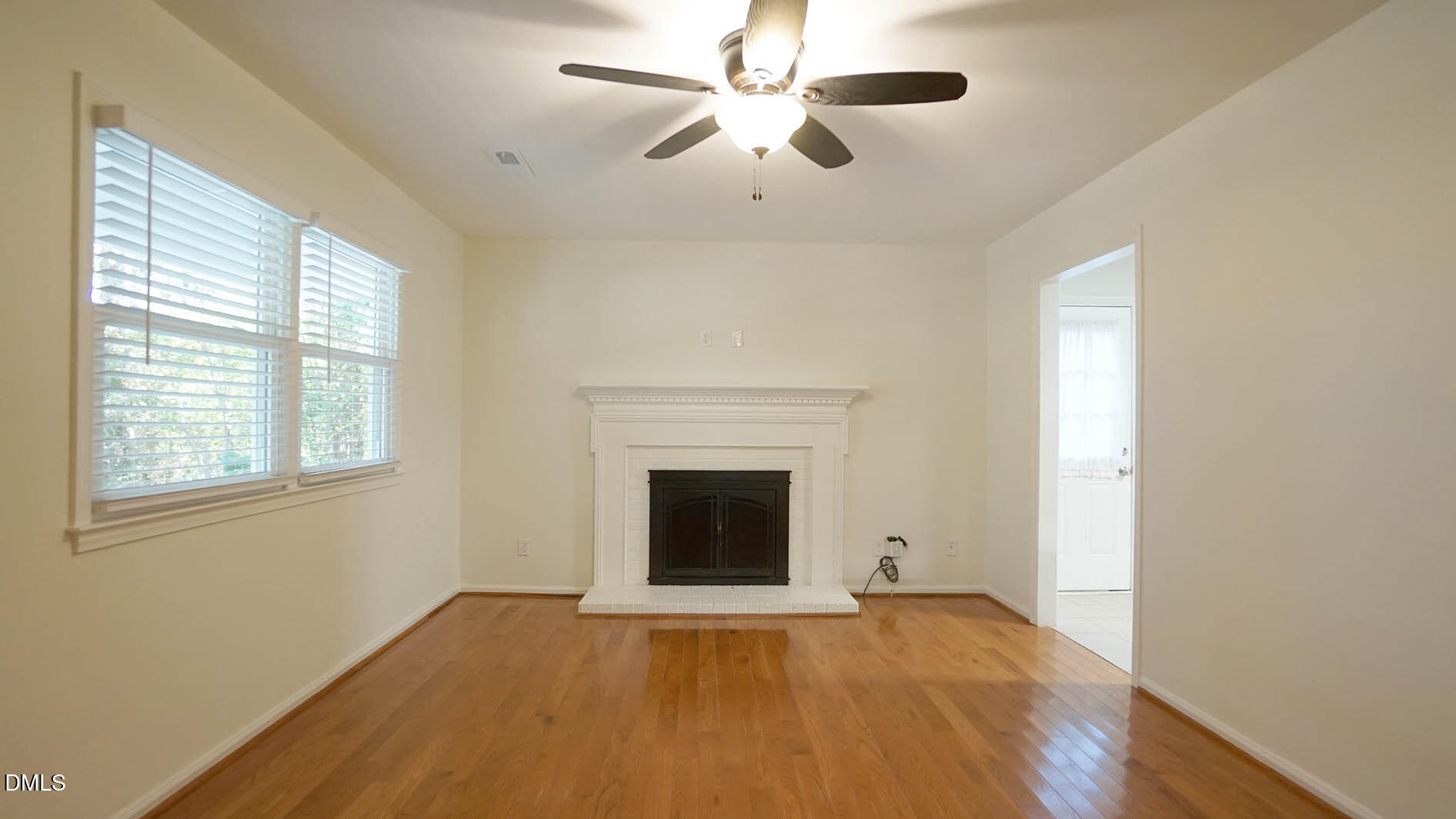 812 Havenwood Court Raleigh, NC 27615 - Photo 10 of 32 a view of empty room with fireplace and wooden floor