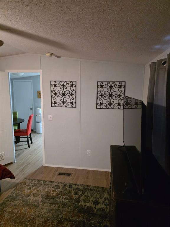 115 Yates Circle Aledo, TX 76008 - Photo 21 of 31 a bedroom with a bed and a table in it