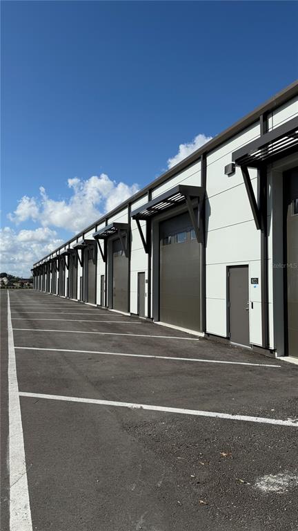 8185 Apex Way Sebring, FL 33876 - Photo 6 of 20 a view of yellow house with a large window and potted plants