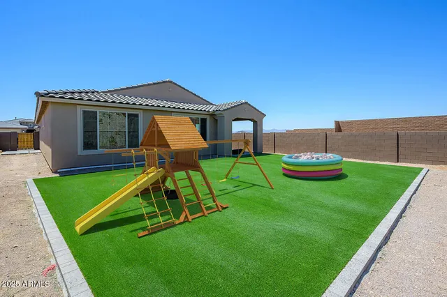 a view of a house with a yard patio and fire pit