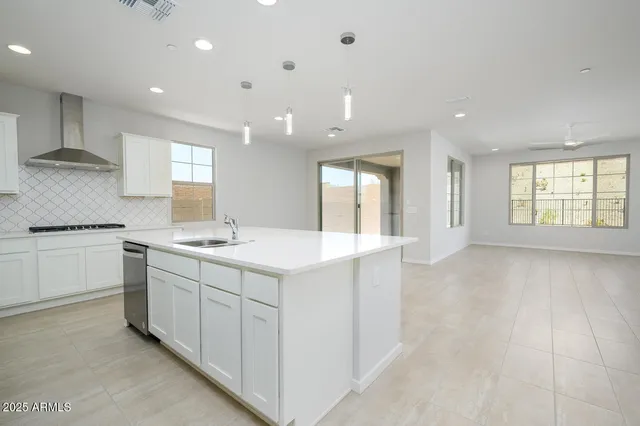 a kitchen with a sink stove and cabinets