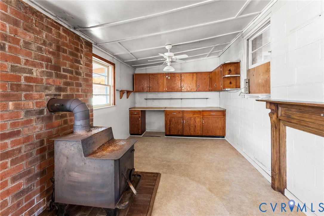 19161 Hollowing Creek Road Beaverdam, VA 23015 - Photo 24 of 27 a kitchen with furniture and a fireplace