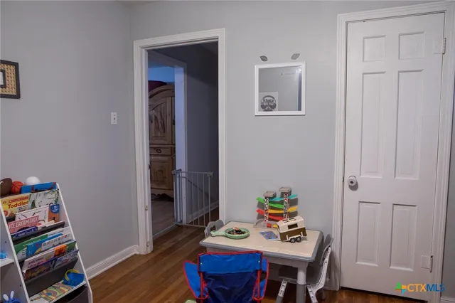 a view of a workspace with furniture and wooden floor