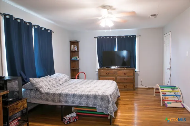 a bedroom with a bed and a flat screen tv
