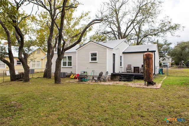 a front view of house with yard and trees around