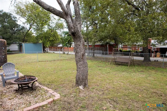 a swimming pool with some trees in the background