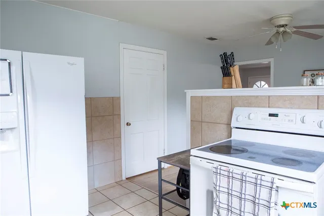 a kitchen with a stove and a refrigerator