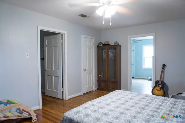 a bedroom with a bed and a chandelier