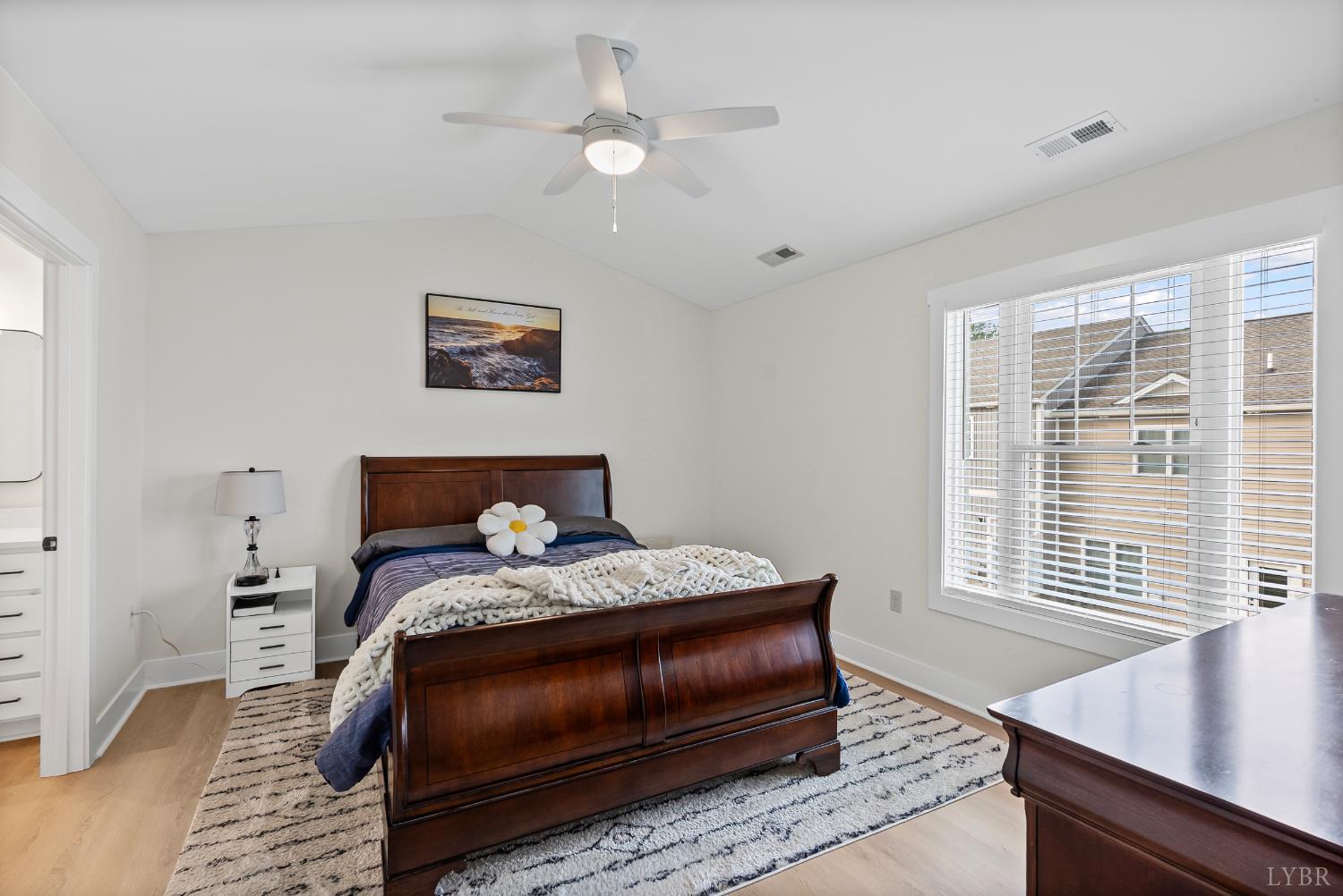 556 Leesville Road, Unit 1001 Lynchburg, VA 24502 - Photo 14 of 22 a bedroom with a bed and a desk with wooden floor